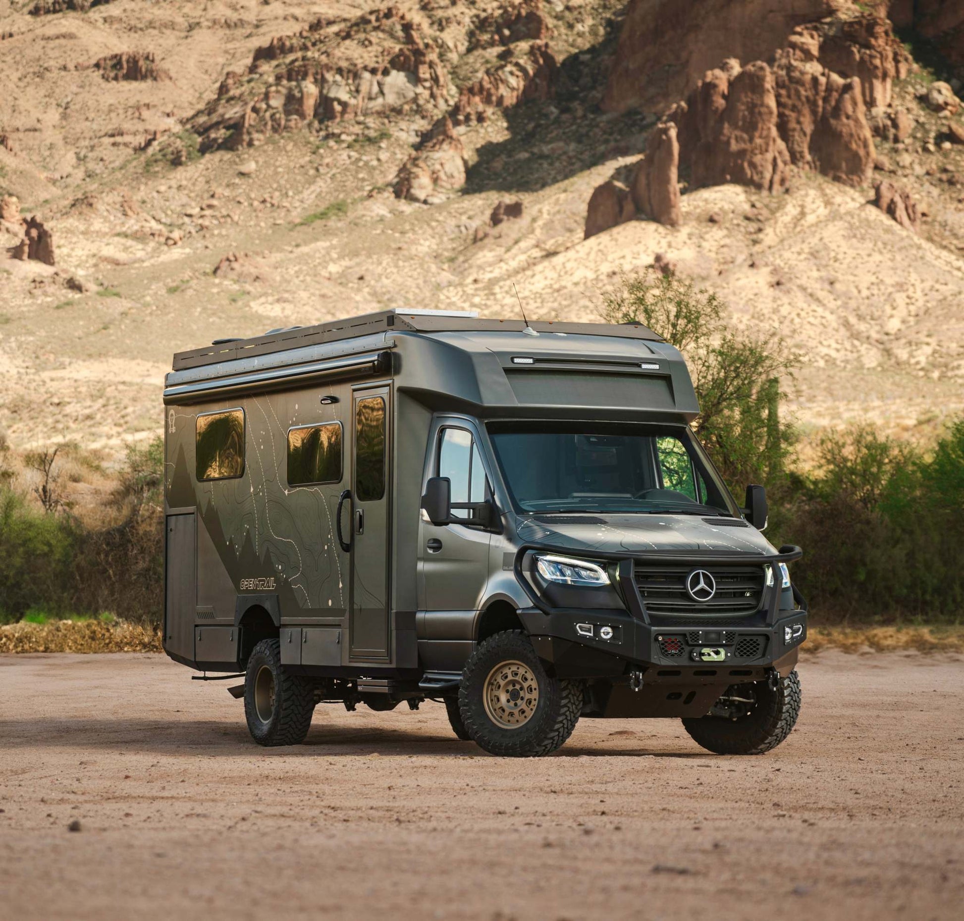 OTX Tiffin adventure van parked in desert landscape with mountainous background