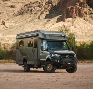 OTX Tiffin adventure van parked in desert landscape with mountainous background