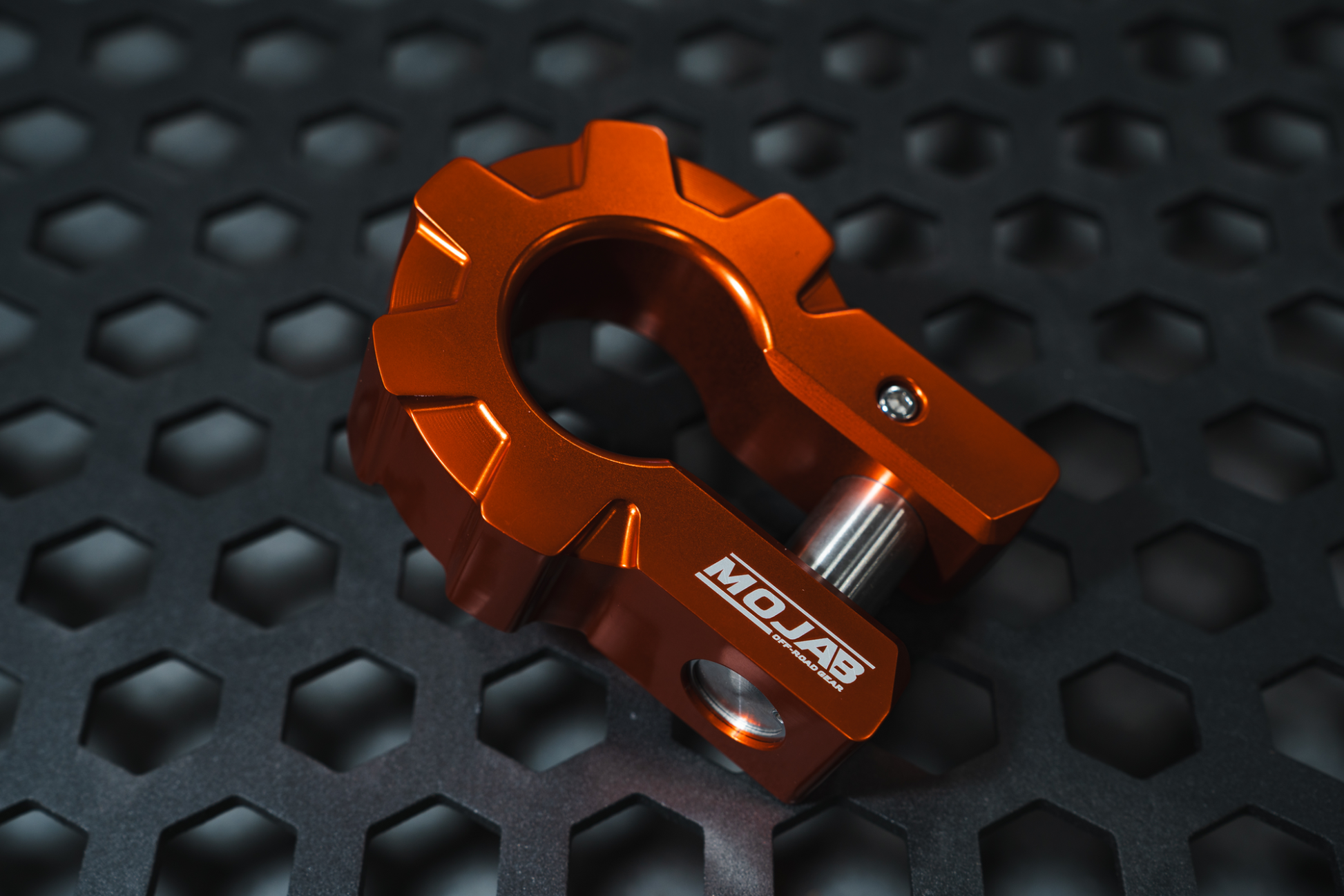 Orange aluminum D-shackle set with MOJAB logo on black textured surface
