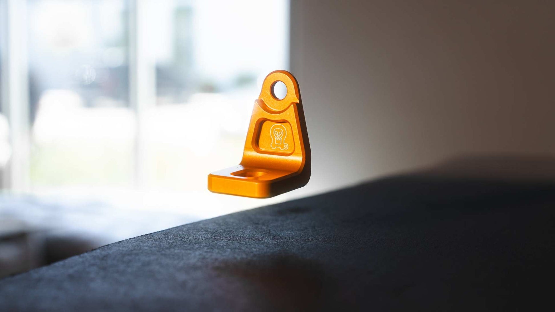 Orange anodized billet aluminum mount for Sprinter Hood Strut Kit close-up