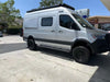 Silver van equipped with matte black Super Single Spare Wheel for off-road use