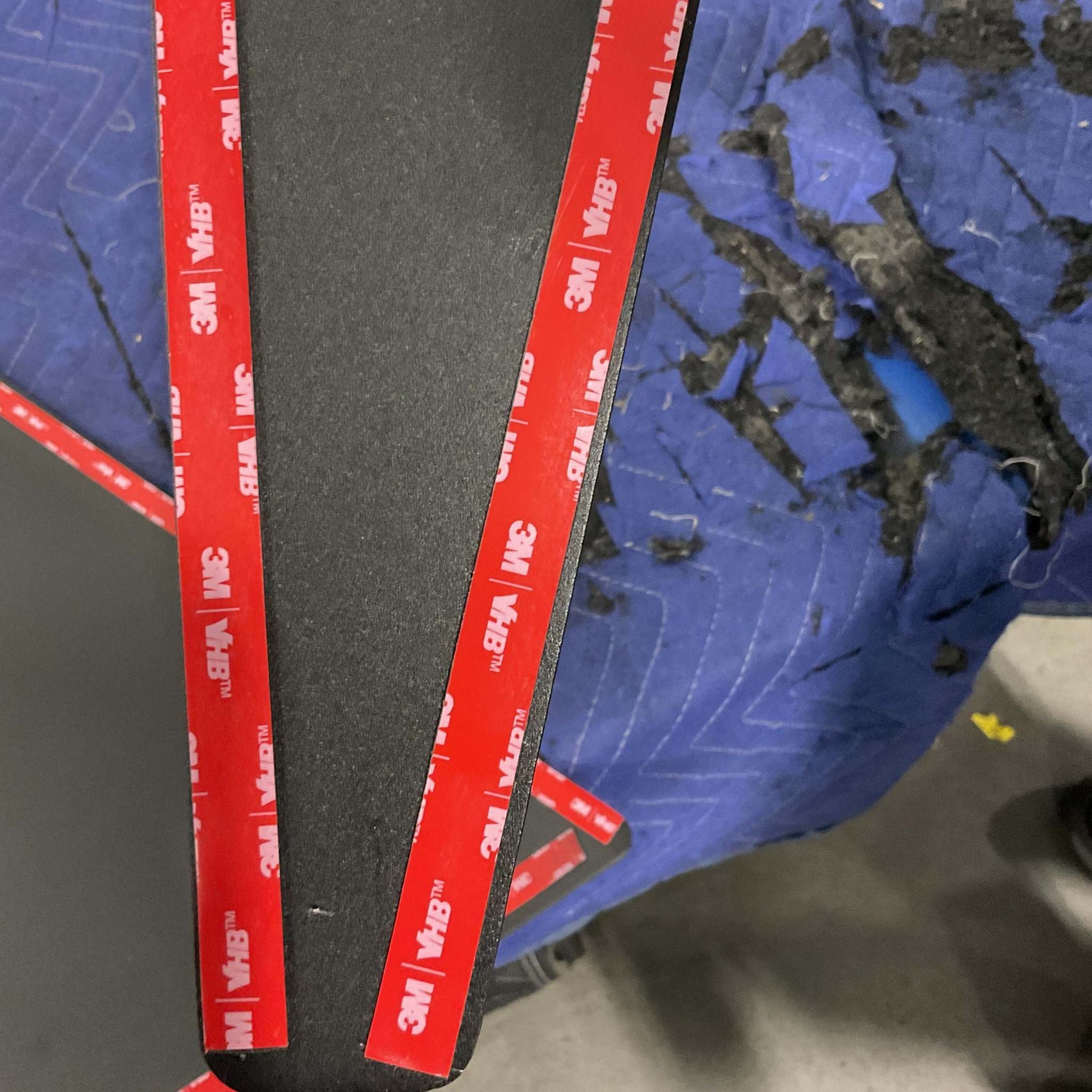 Grenadier Fender Armor Plates with 3M adhesive strips on a textured blue surface, designed for durable vehicle upgrade.