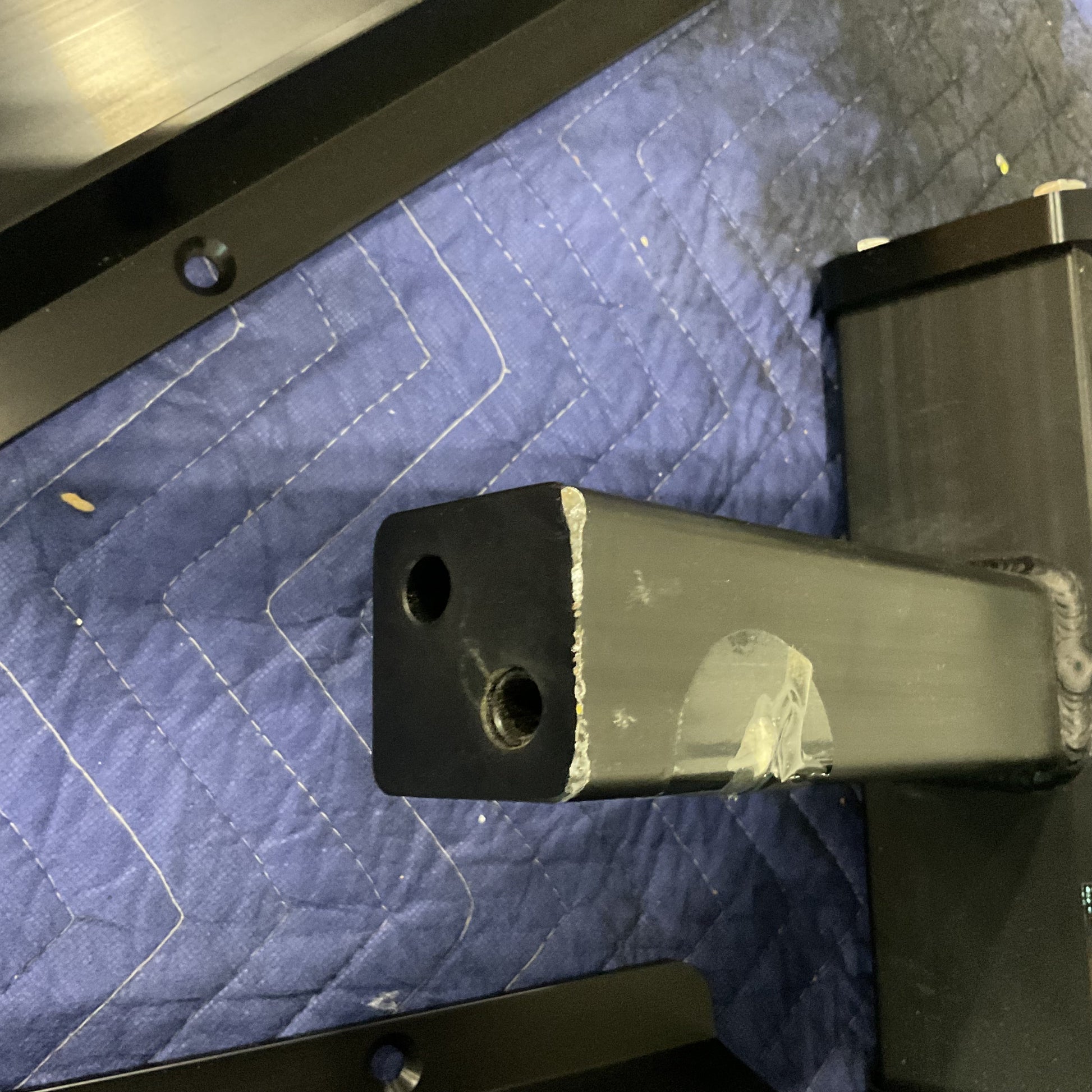 Close-up of 2-inch Super Duty Hitch receiver part of double bike rack on protective blue pad