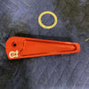 Red Grenadier Hood Release Handle by Owl with a small round gasket on a dark padded surface