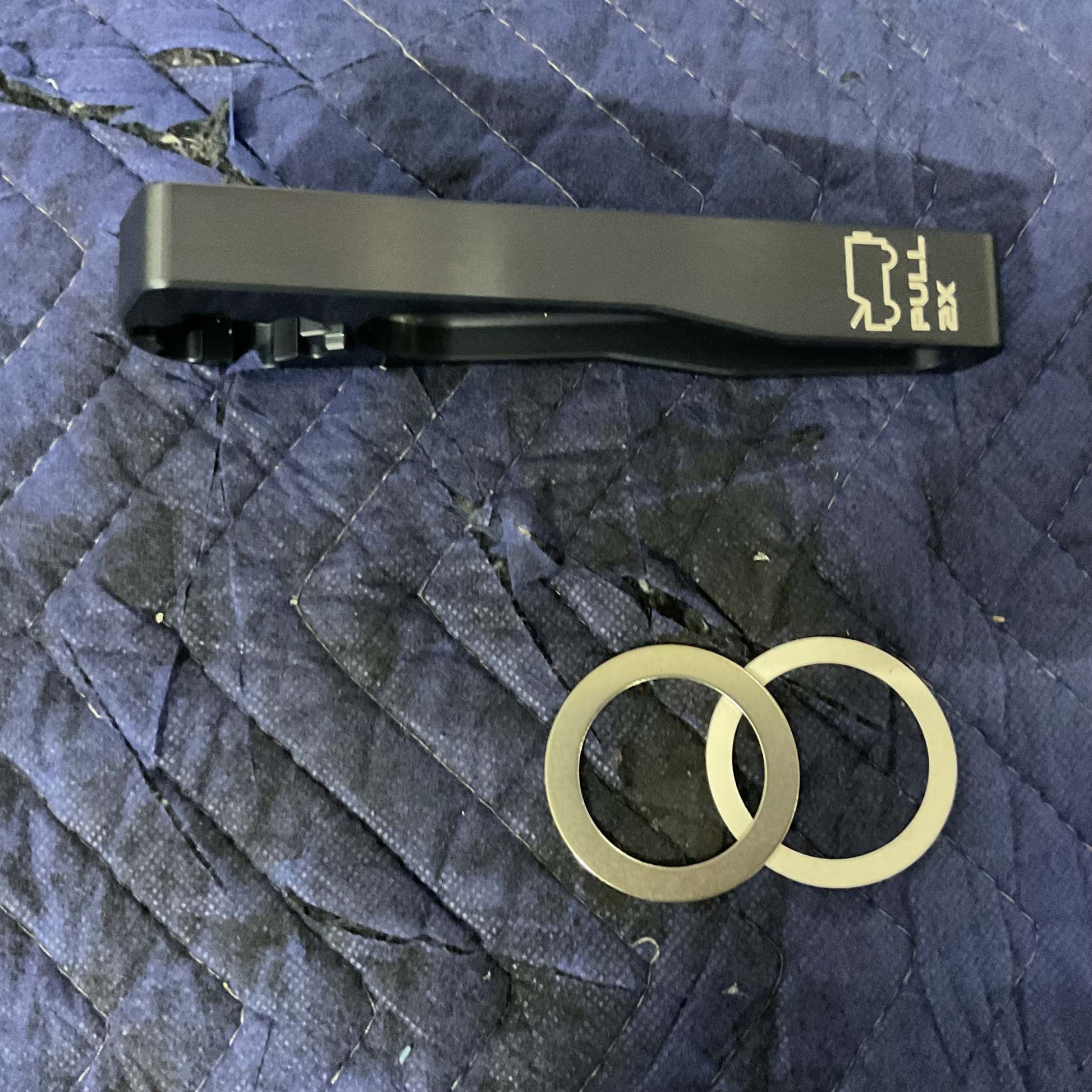 Grenadier Hood Release Handle and mounting rings on quilted fabric background
