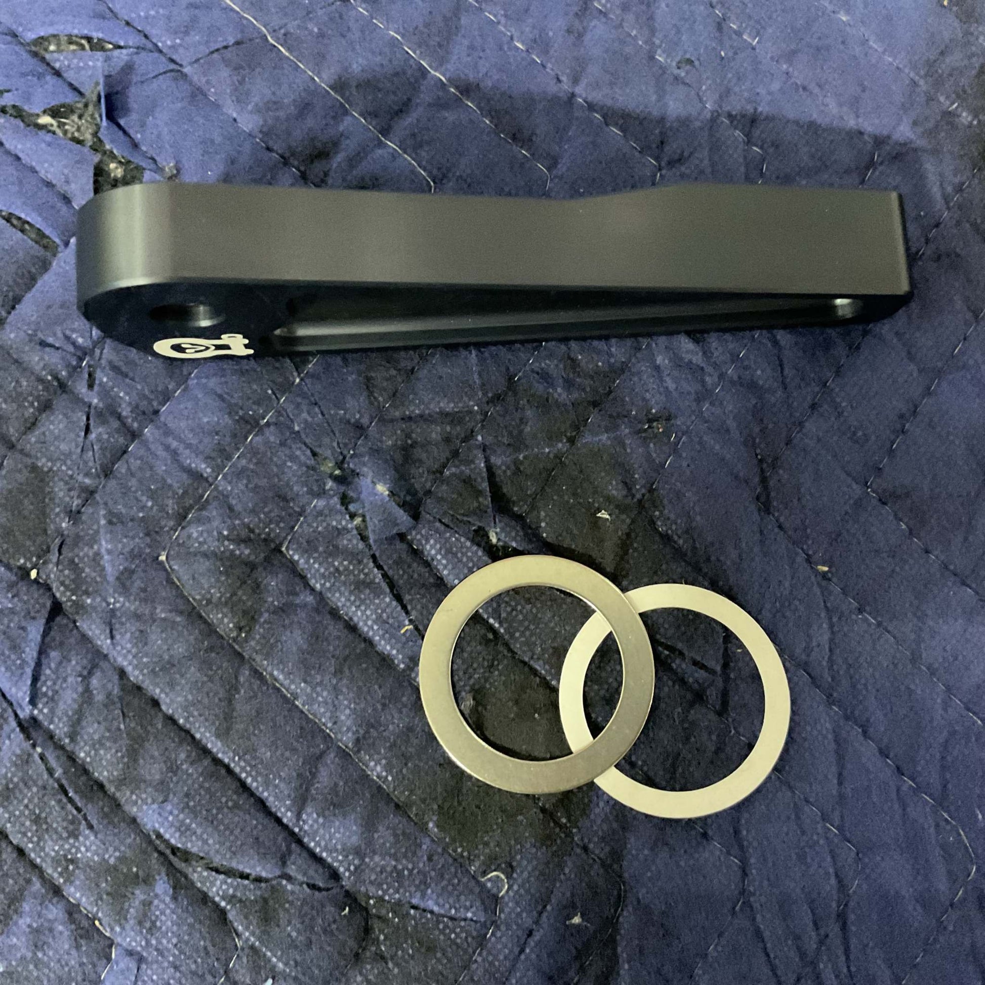 Grenadier Hood Release Handle with mounting rings on blue padded surface for INEOS Grenadier upgrade
