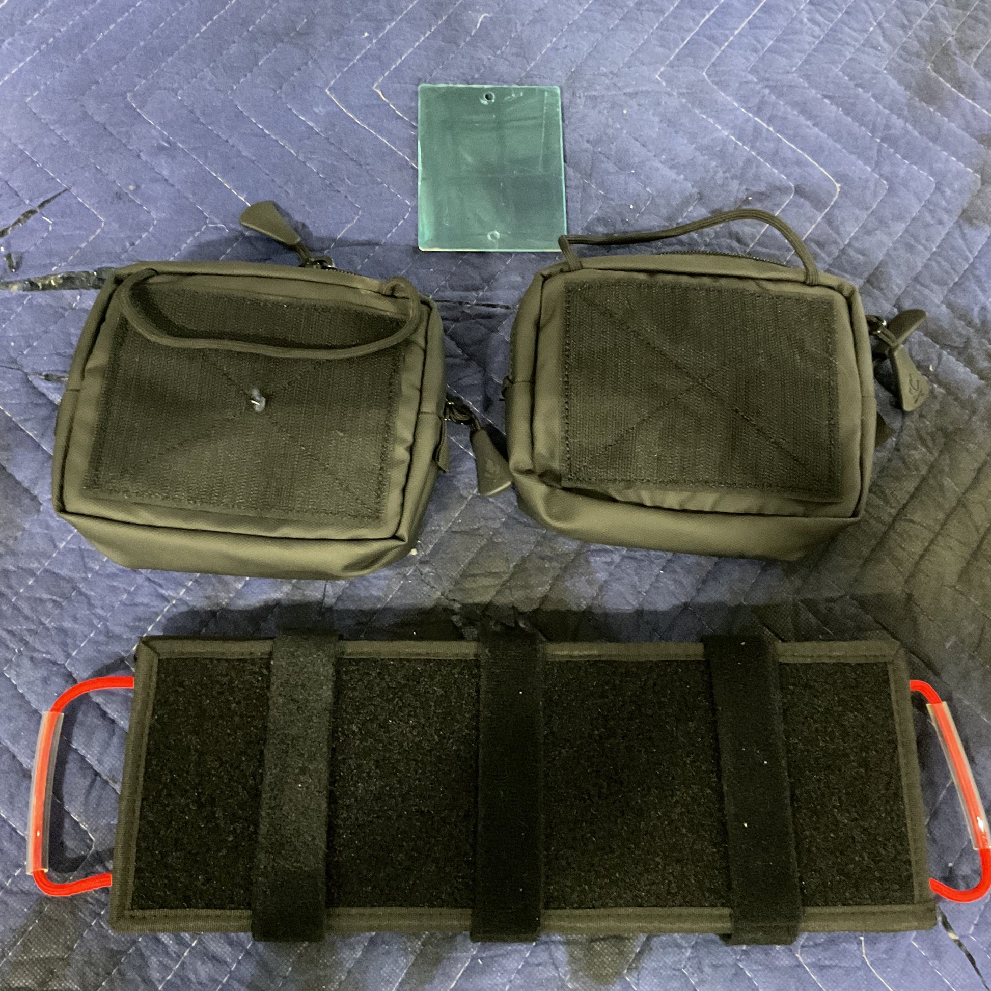 Modular Visor Panel with tactical pouches and attachment straps for vehicle gear storage