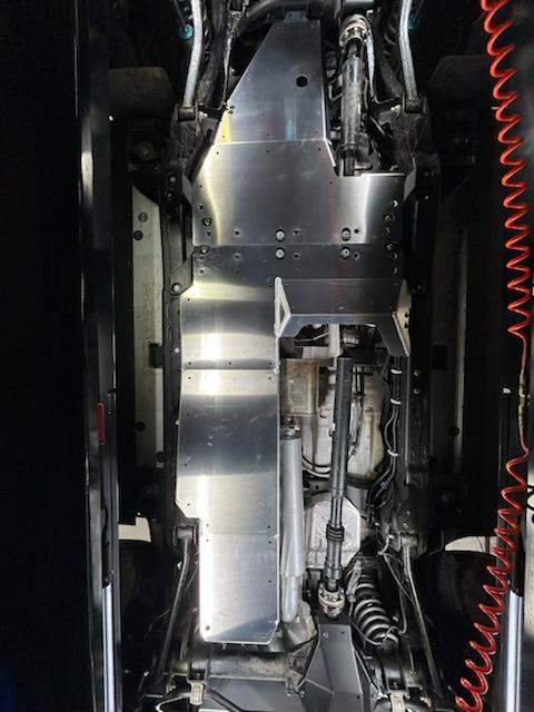 Grenadier skid plate system installed on vehicle undercarriage for drivetrain protection