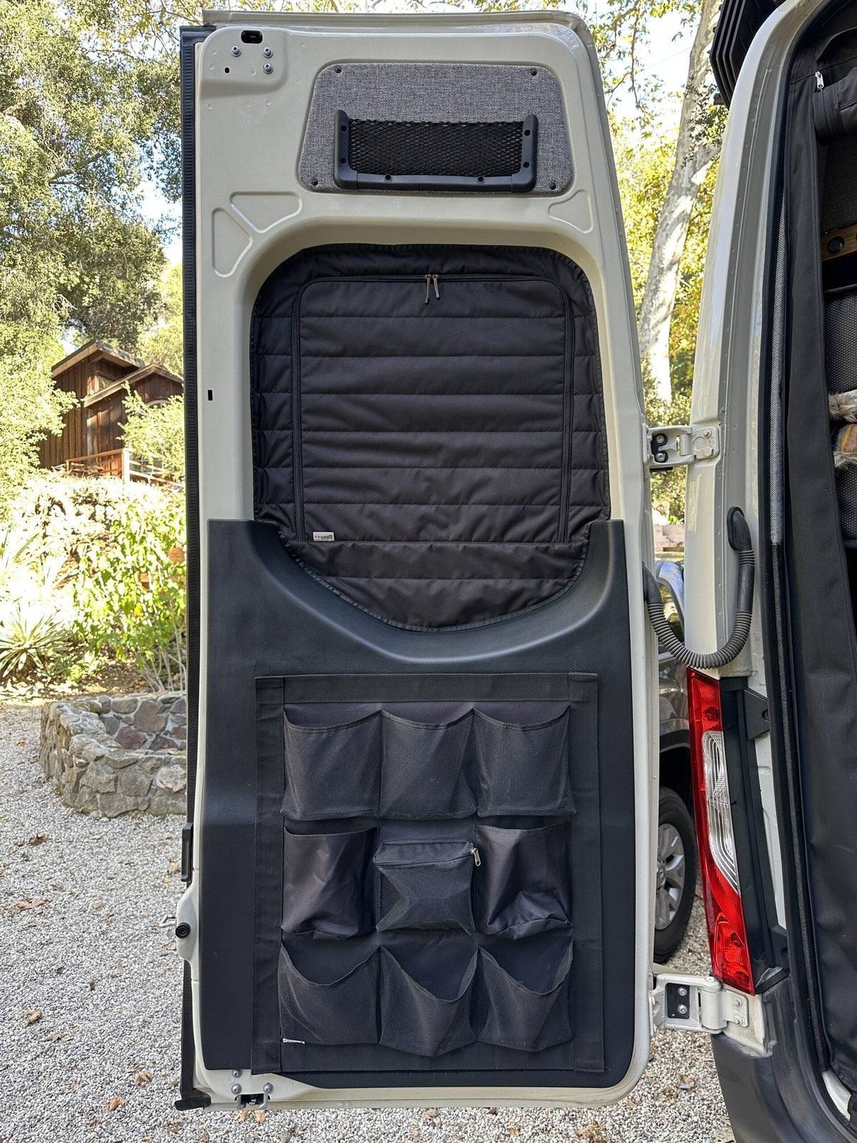 Insulated Sprinter rear window cover with zippered access and storage pockets on van door interior