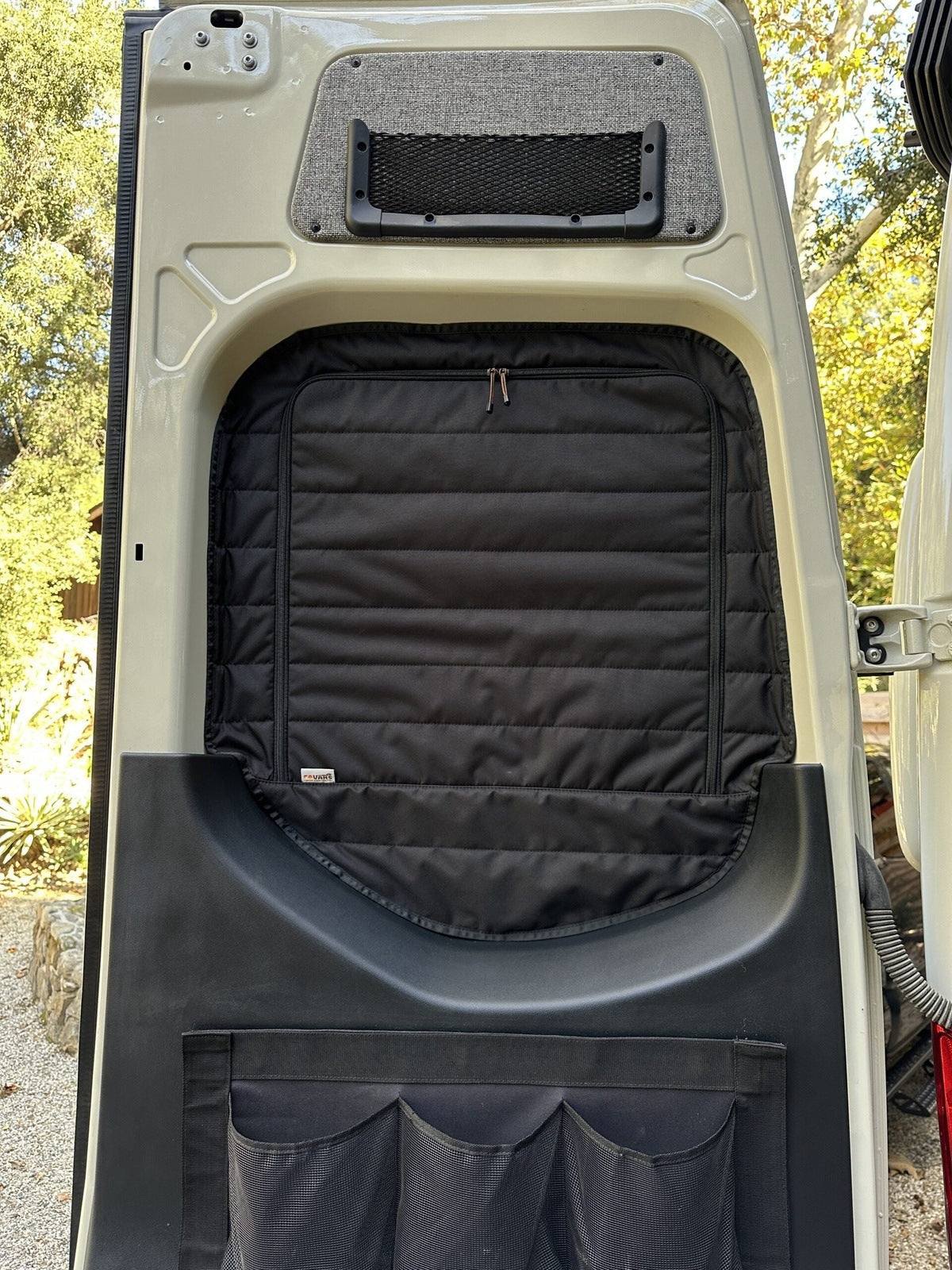 Insulated black Sprinter rear window cover with zippered access installed on van door