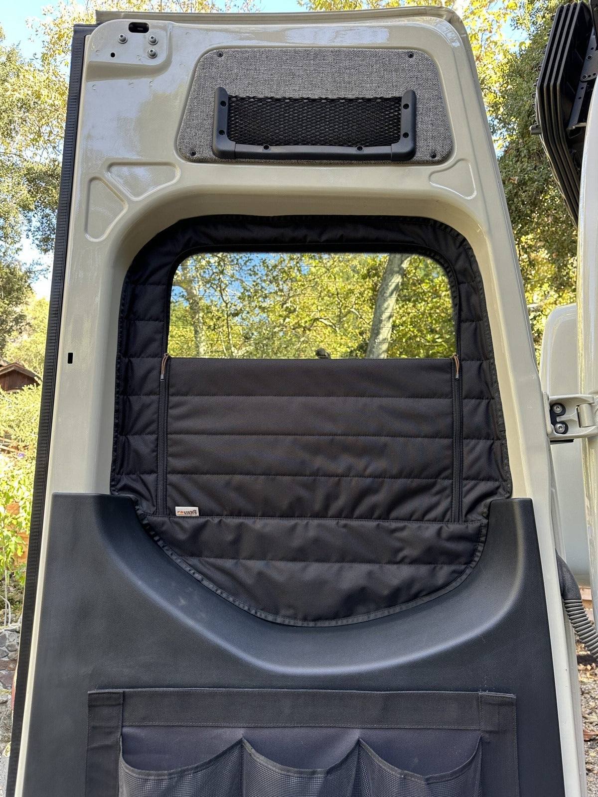 Insulated CLIMA-SHADE Sprinter rear window cover installed on open van door with zippered airflow access