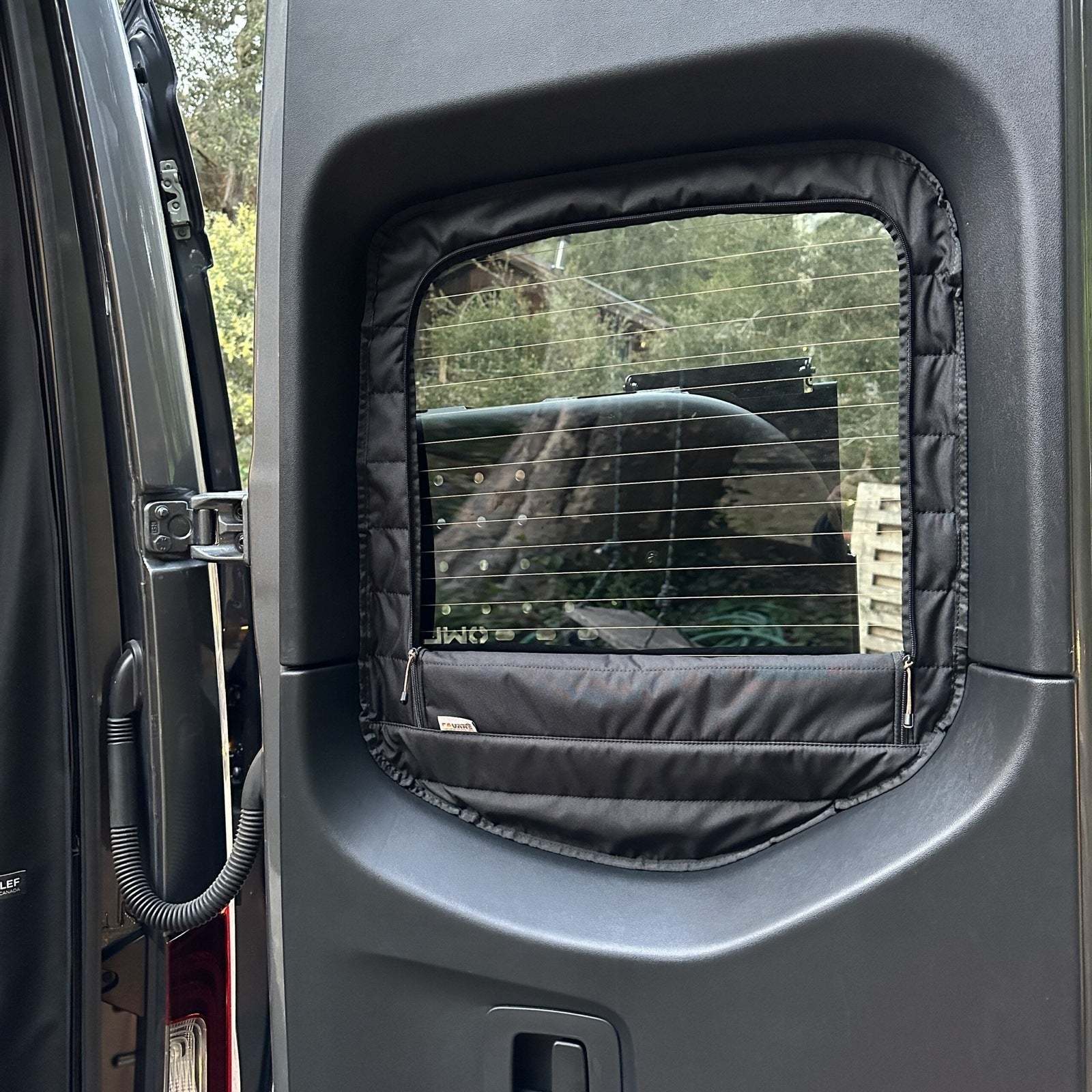 Sprinter van rear window with CLIMA-SHADE insulated cover featuring zippered access for airflow and temperature control