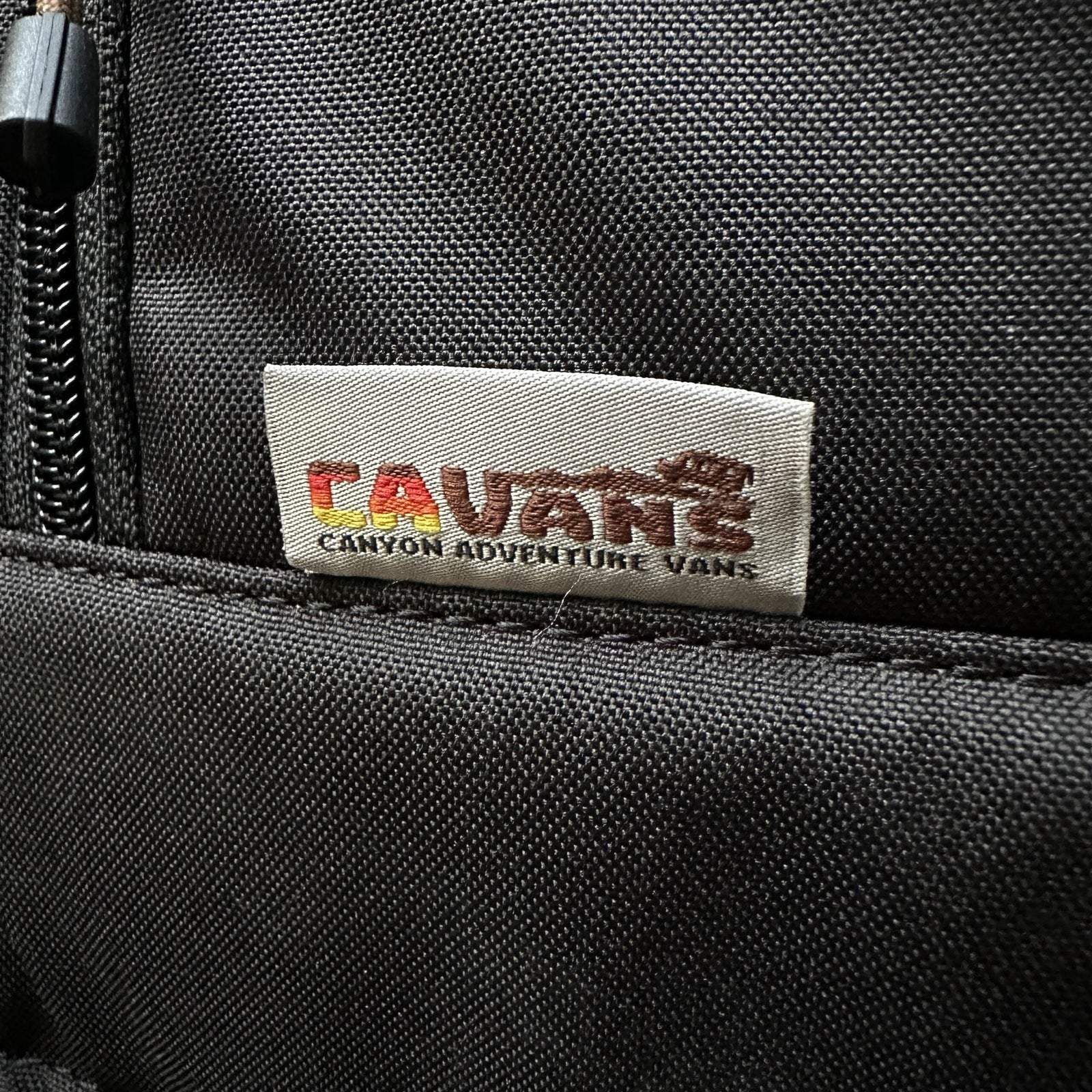 Close-up of black CLIMA-SHADE insulated Sprinter rear window cover fabric with Rauan Canyon Adventure Vans label