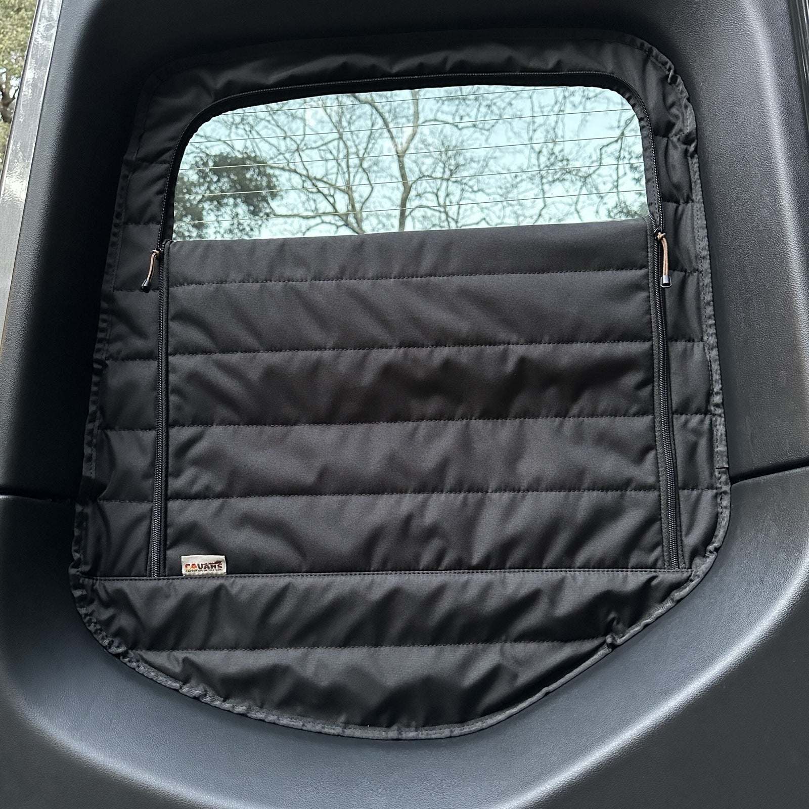 Insulated black CLIMA-SHADE Sprinter rear window cover with zippered airflow access installed on van window