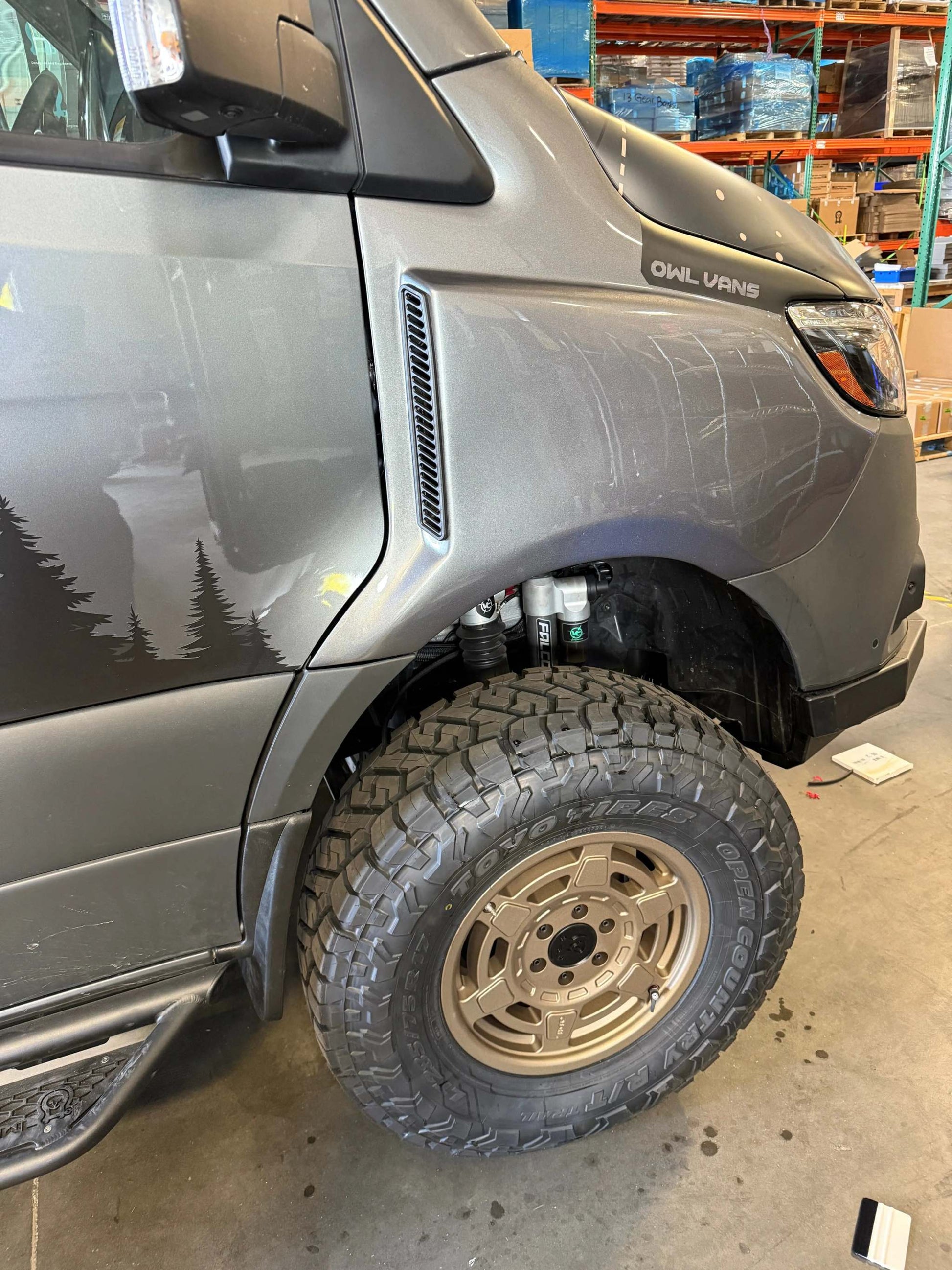 Sprinter van front fender with rugged trail fender flare and off-road tire installed