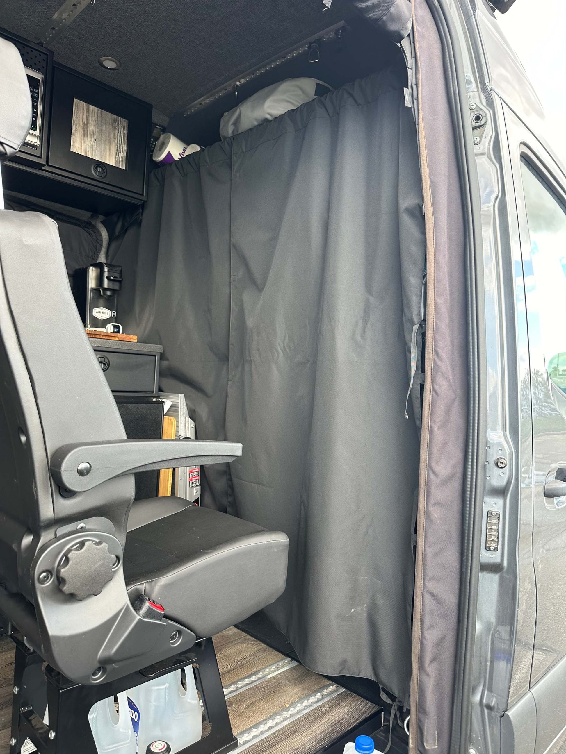 Stealth Blackout Curtain installed in van dividing front seat area for privacy and heat blockage