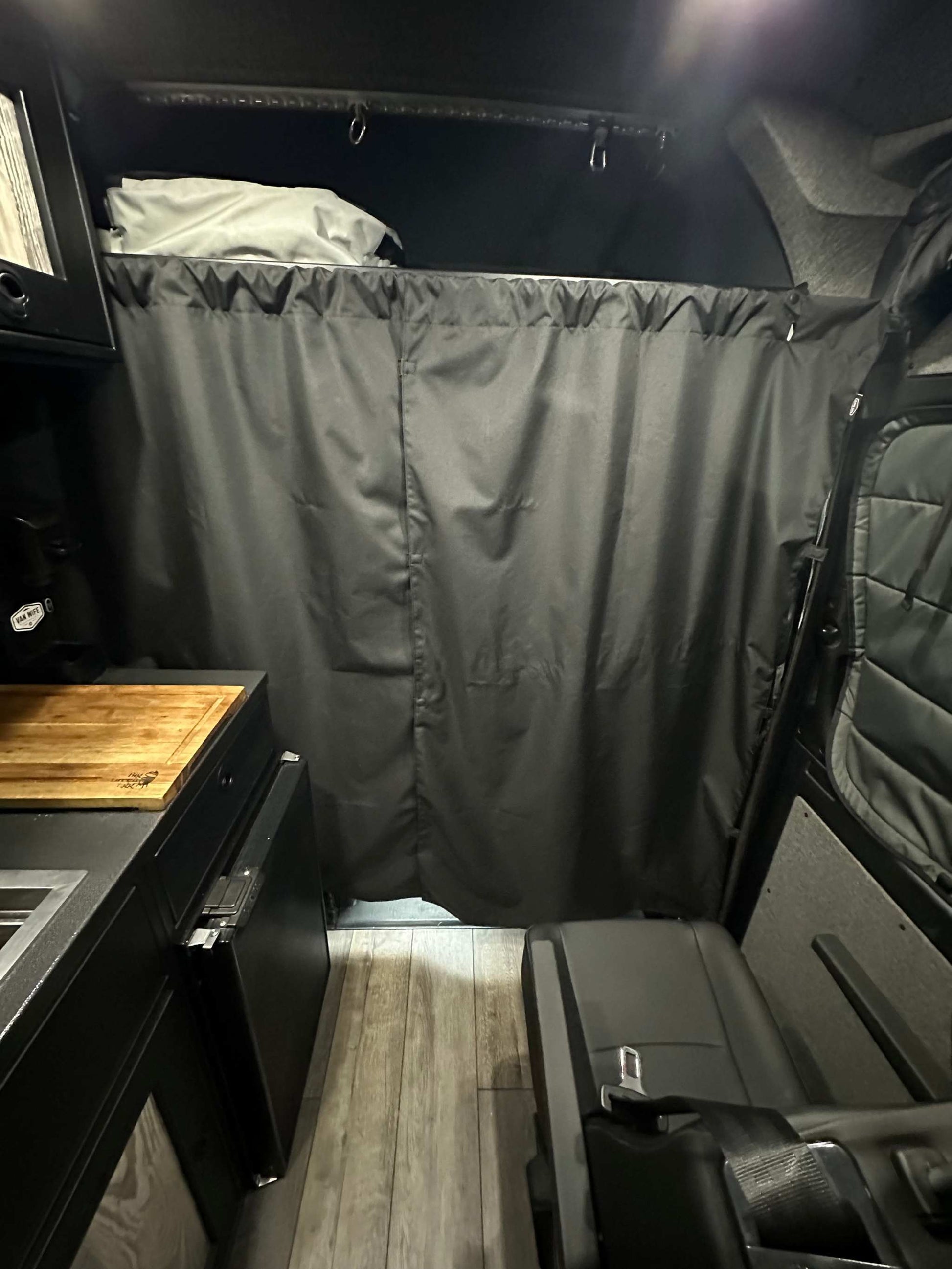 Stealth Blackout Curtain inside van for privacy and heat blockage during urban camping