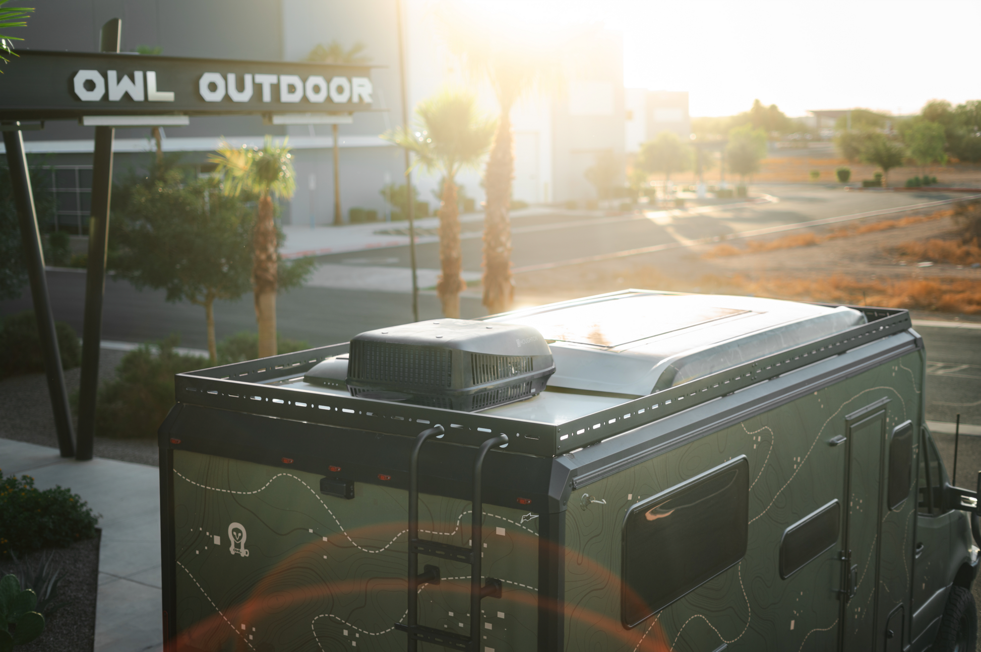 Black lightweight aluminum Ekko Roof Rack installed on Winnebago Ekko with 360-degree offroad lighting setup and sleek enclosed design
