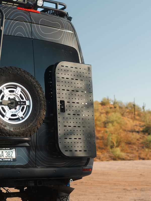 Sprinter bike rack and box carrier mounted on rear door of van in outdoor setting