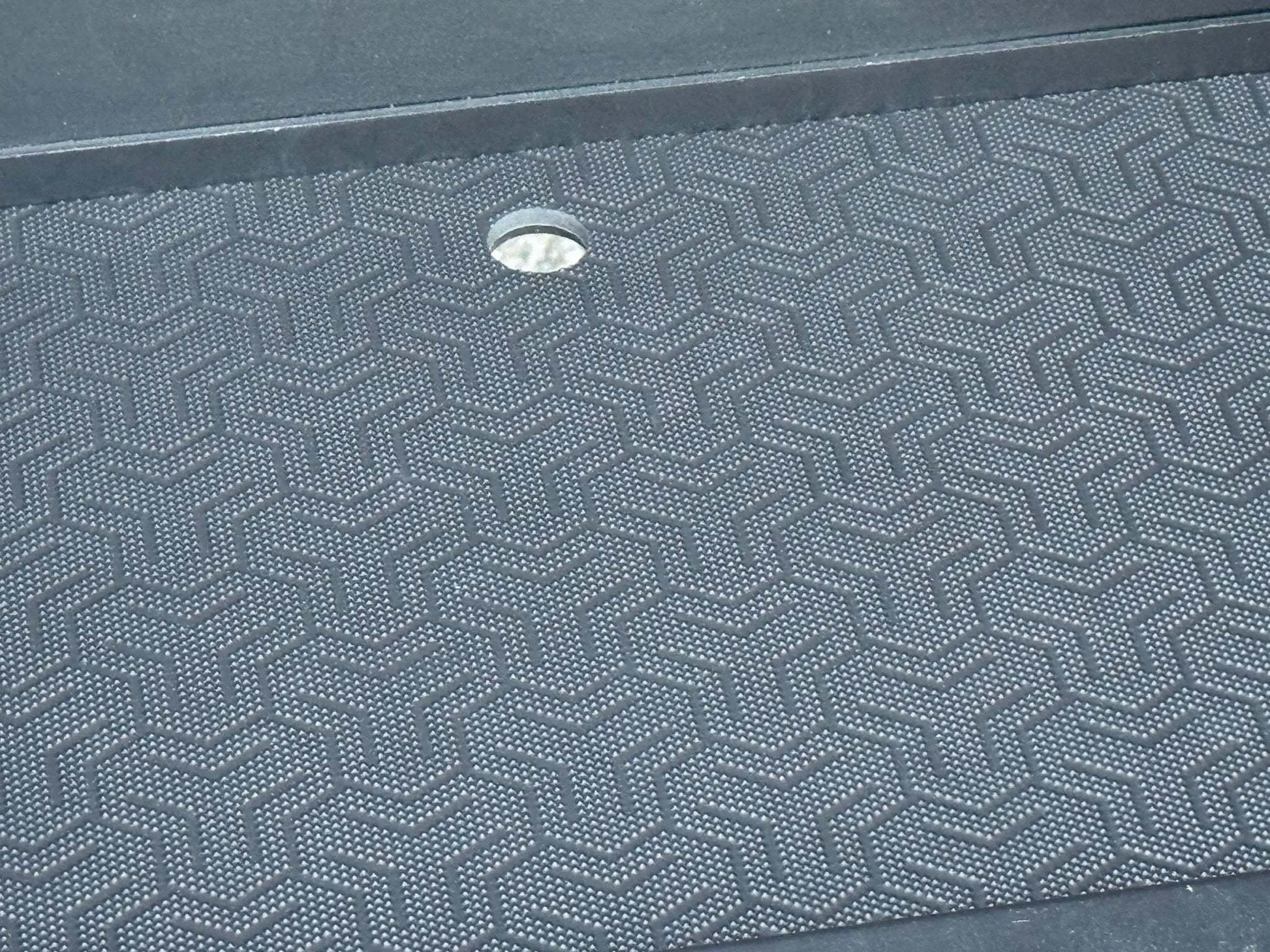 Close-up of textured black surface inside a van storage box base