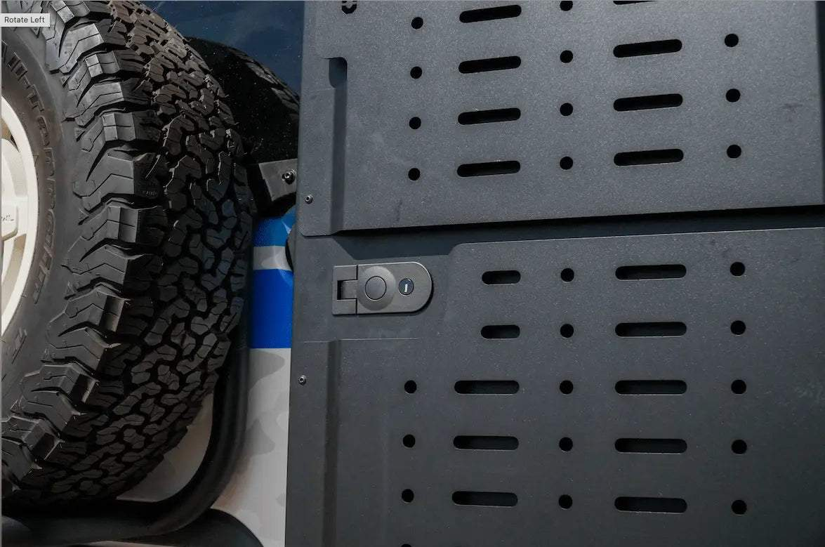 Black Alpine van storage box with lock and ventilation slots next to spare tire