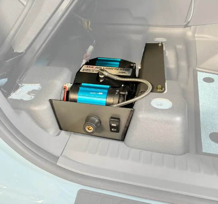 Underseat air compressor system for INEOS Grenadier installed beneath seat.