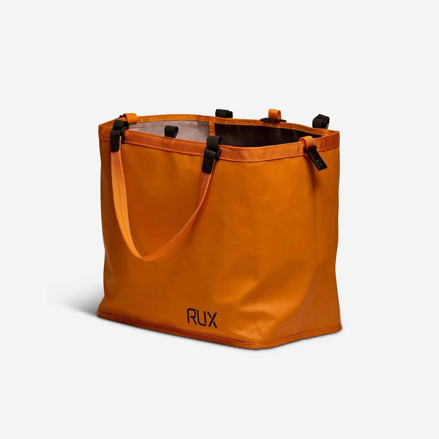 Orange RUX 25L Bag with handles, versatile and easy to pack for convenient storage.