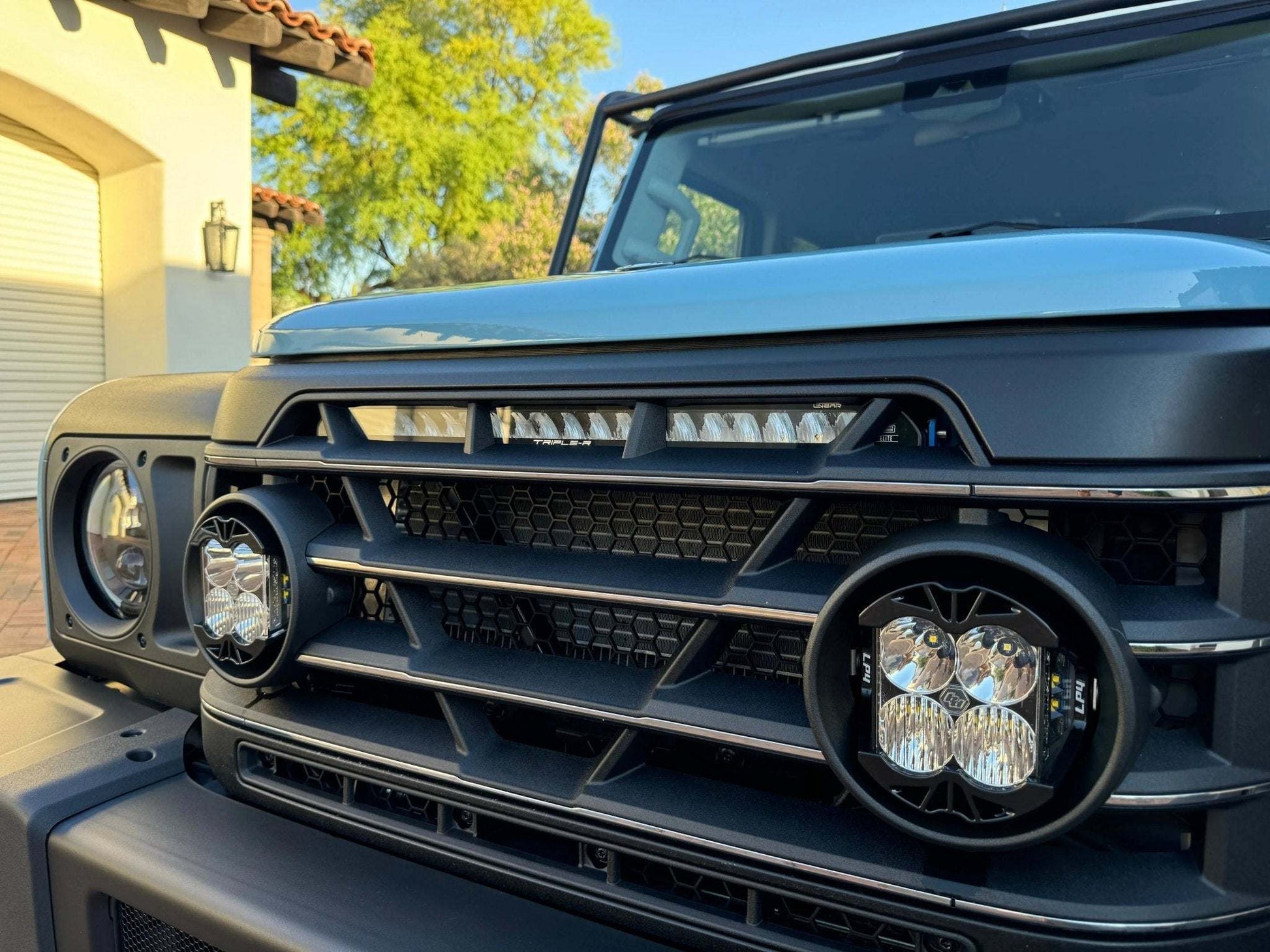 LP4 Grille Light Mounts installed on INEOS Grenadier showcasing rally-inspired lighting integration.
