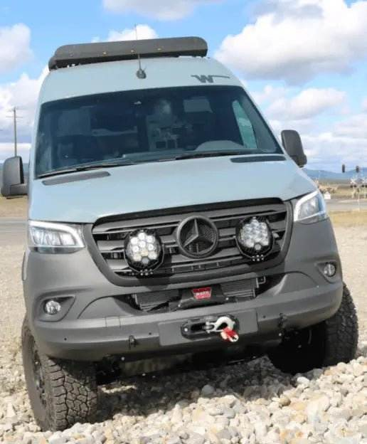 Front view of a rugged off-road van equipped with dual LP9 Sport LED Lights mounted on the grill