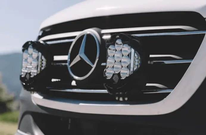 Close-up of LP9 Sport LED Light mounted on vehicle grille with Mercedes emblem