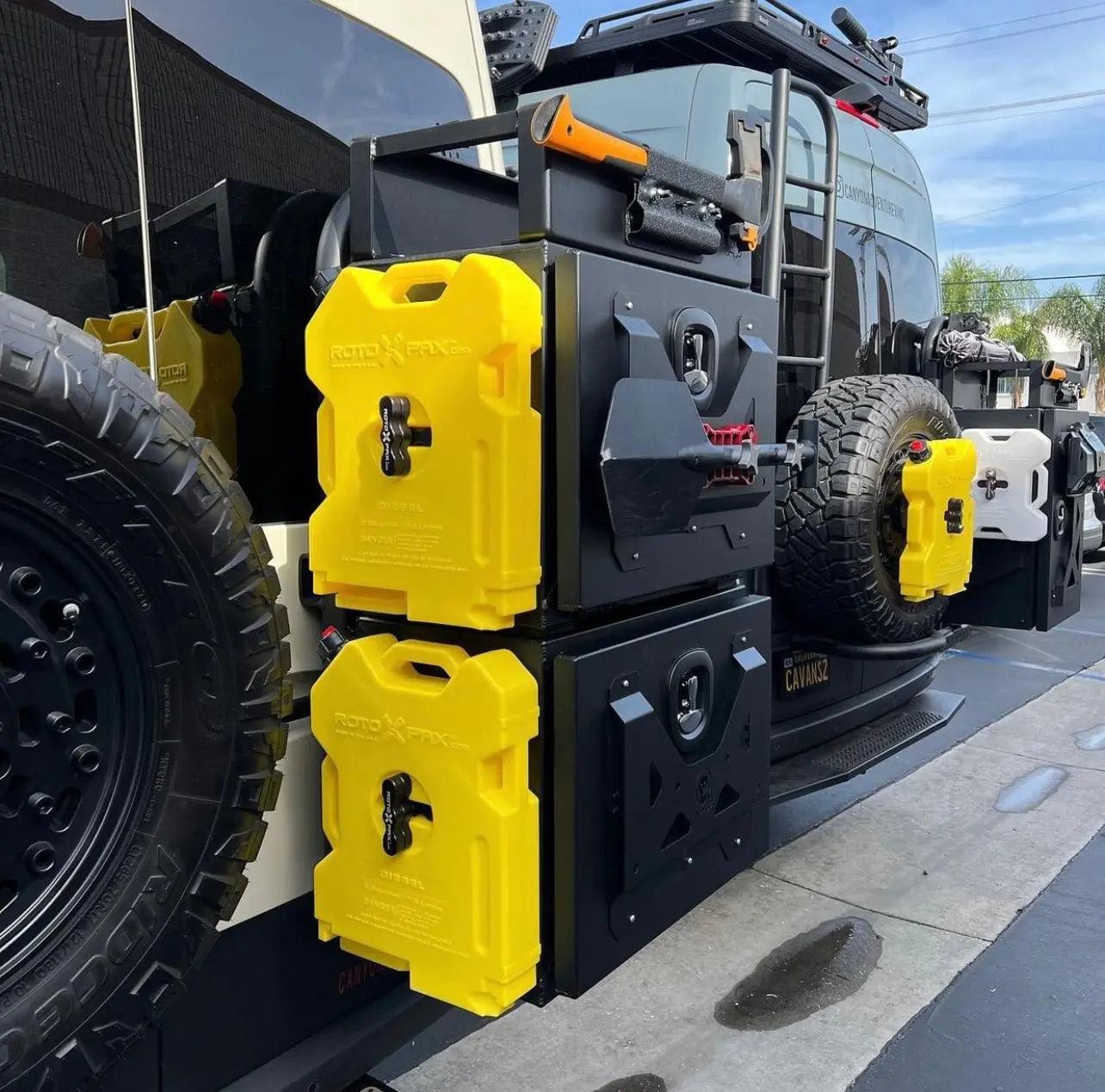 Medium Expedition Cargo Box mounted on vehicle rear with yellow fuel containers and rugged design for durability and lightweight use