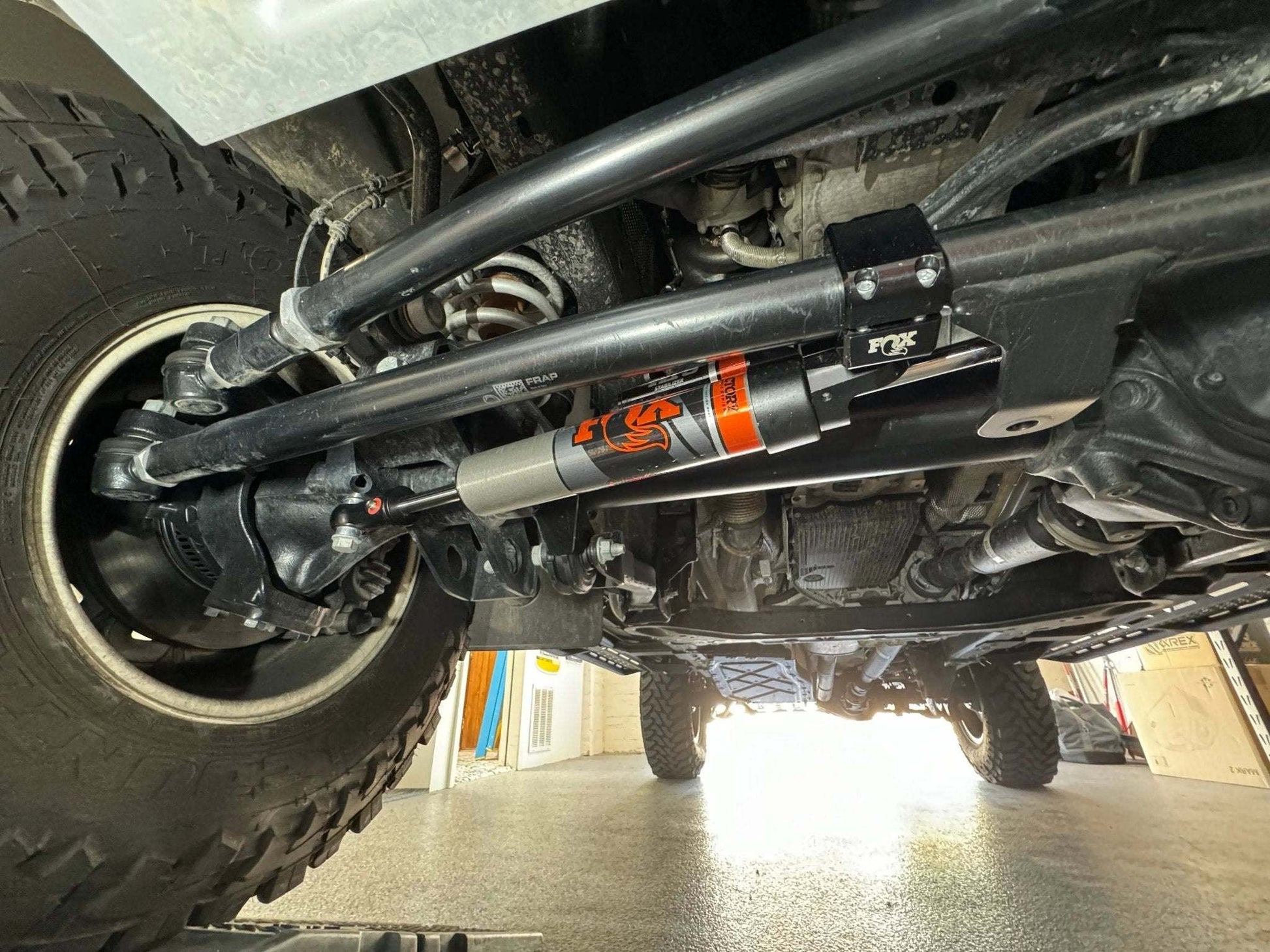 Race Series 2.0 ATS Grenadier Steering Stabilizer installed on INEOS Grenadier, enhancing off-road performance and ride quality.
