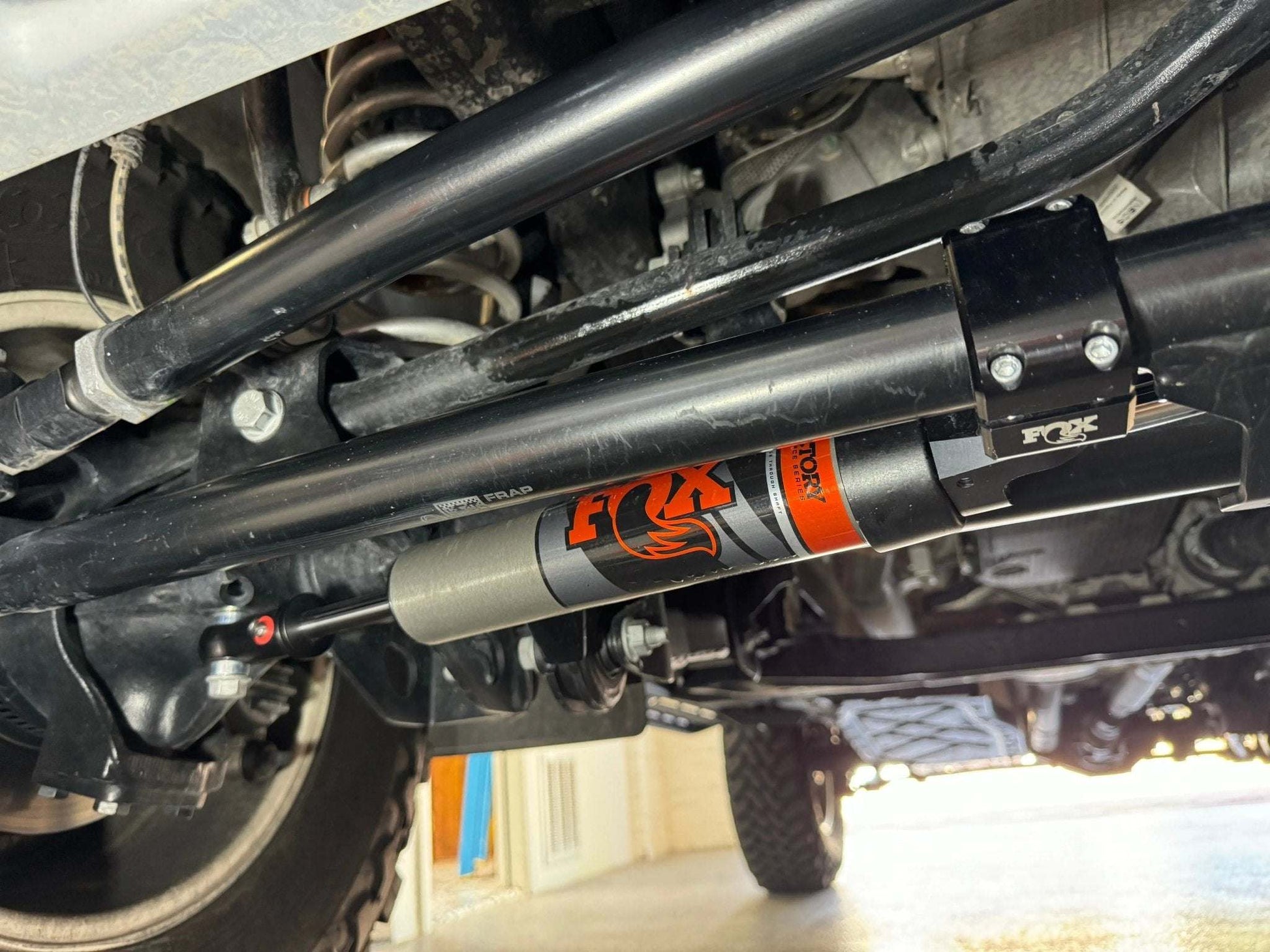 Race Series 2.0 ATS Grenadier Steering Stabilizer for INEOS Grenadier under vehicle suspension.