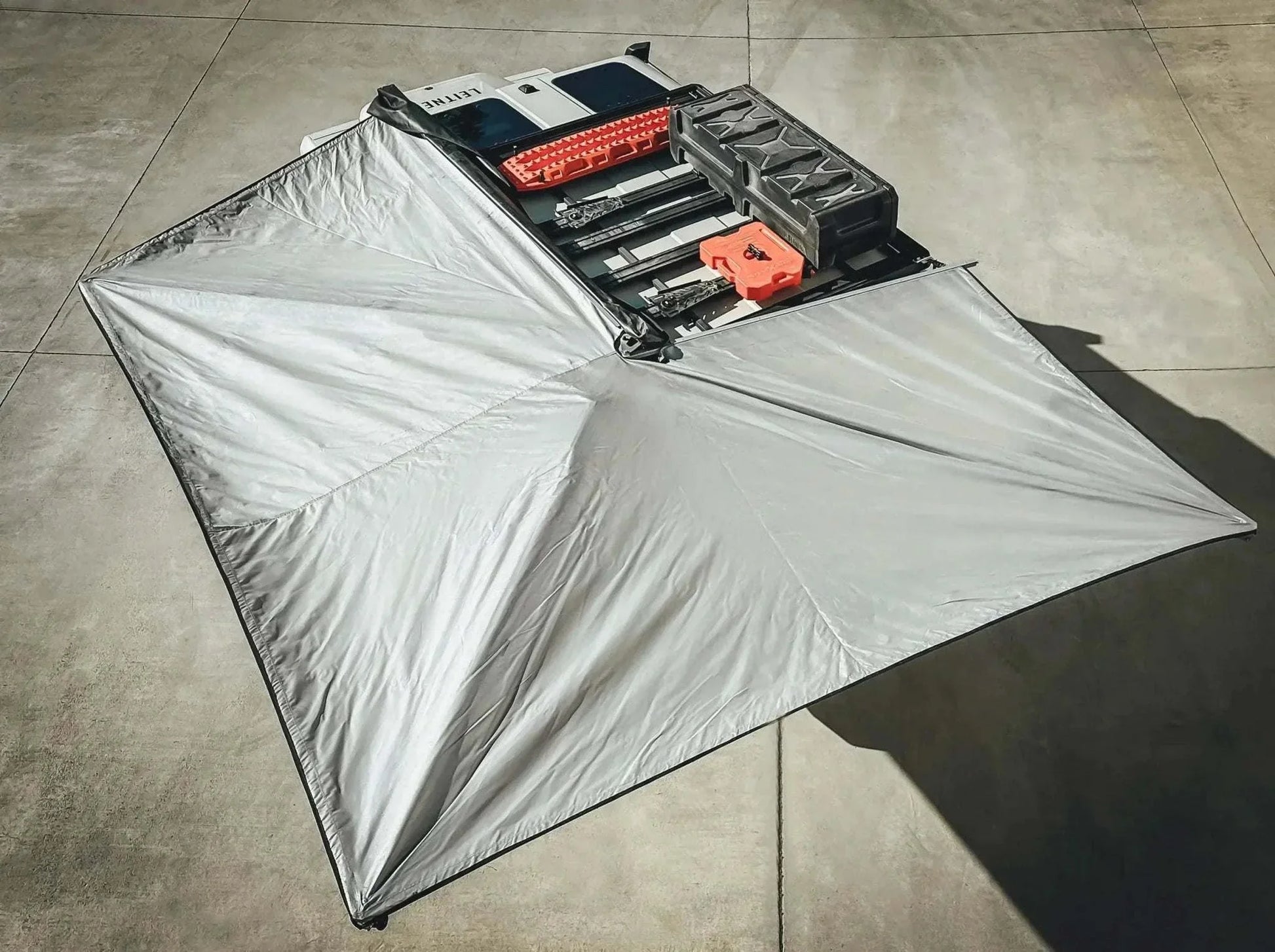 HD Awning Bracket for INEOS Grenadier supporting a robust expedition-grade awning on a roof rack system.