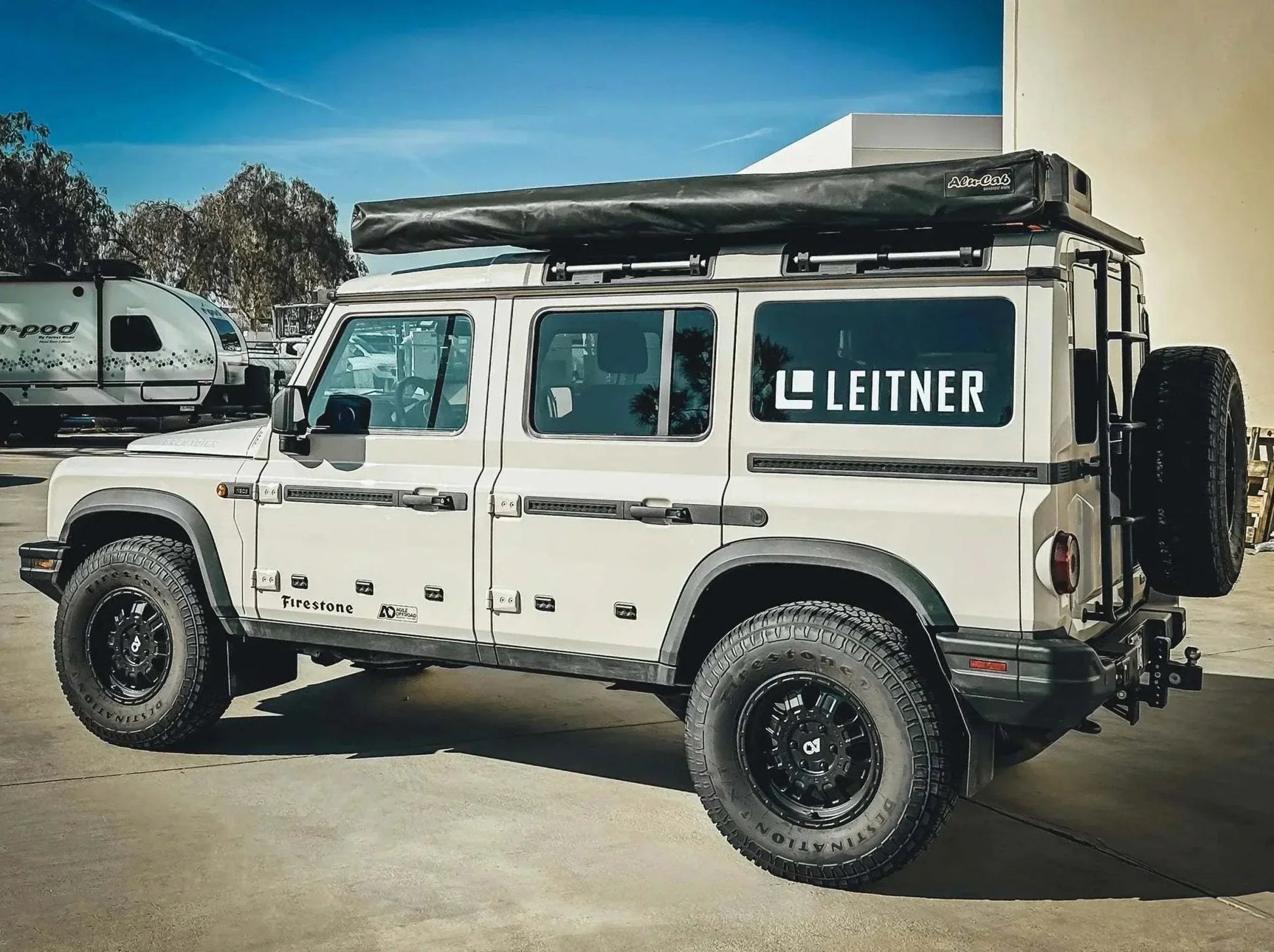 HD Awning Bracket for INEOS Grenadier by Leitner Designs, mounted on a rugged vehicle for expedition-grade durability and weather protection.