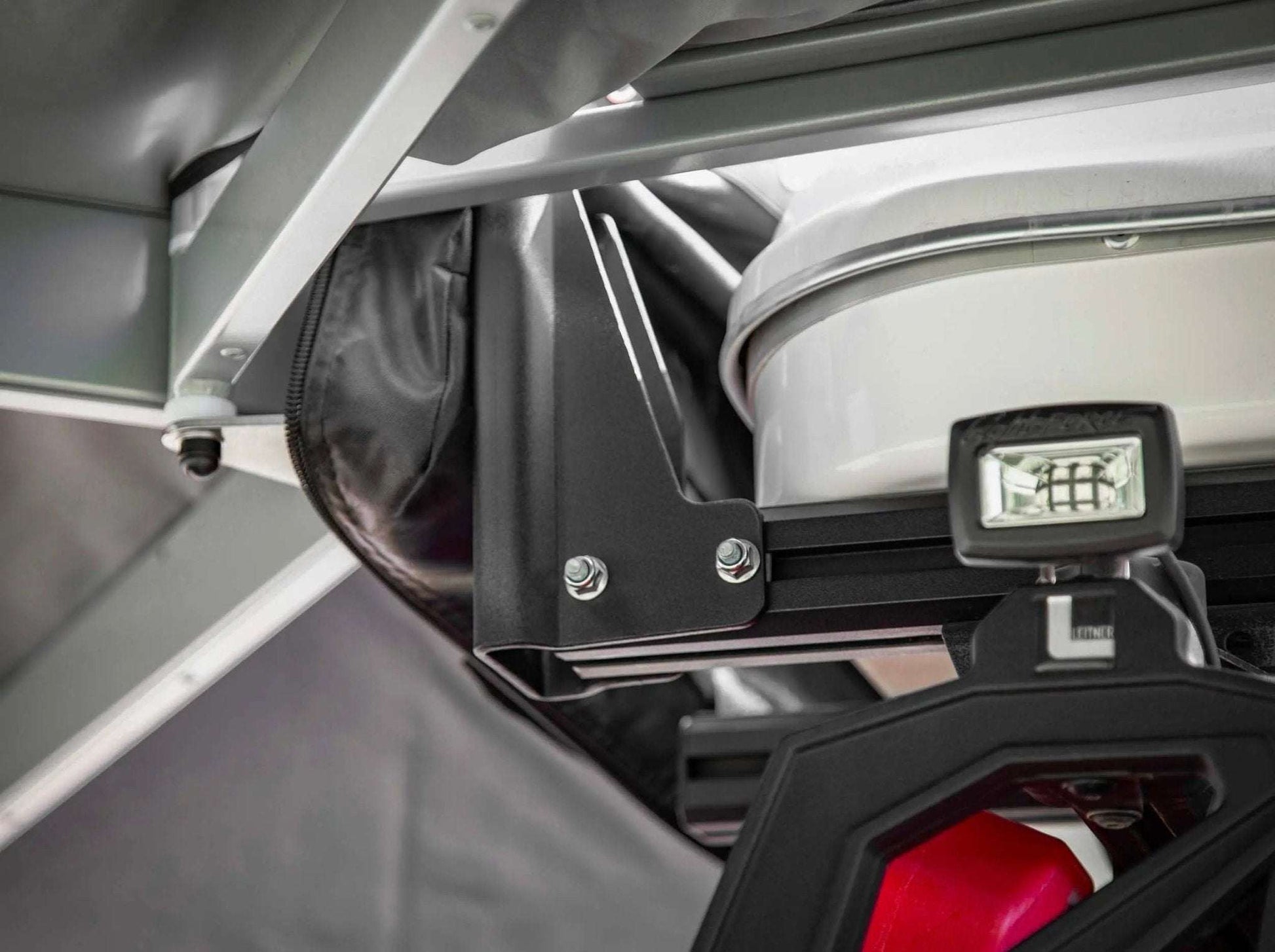 HD Awning Bracket for INEOS Grenadier mounted in roof rack system providing secure support.