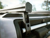 Load Bar Kits for INEOS Grenadier installed on vehicle roof, showcasing durable and sleek design by Leitner Designs.