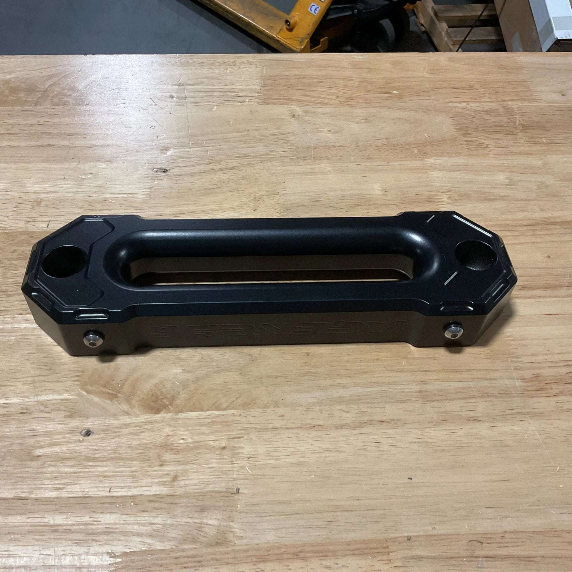 Black winch fairlead with minor scuffs, made of 6061-T6 aluminum, satin black finish, perfect working condition, includes stainless mounting hardware.