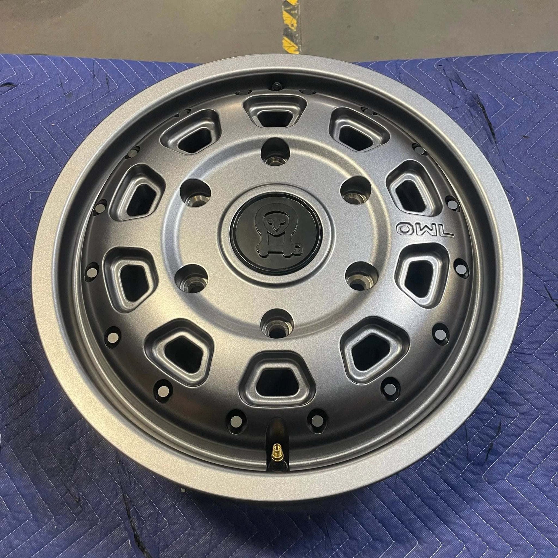Graphite grey Talon Transit AWD wheel with minor scuffs, lightweight aluminum, 17x7 inch, 6x180mm bolt pattern, and dual valve stem system.