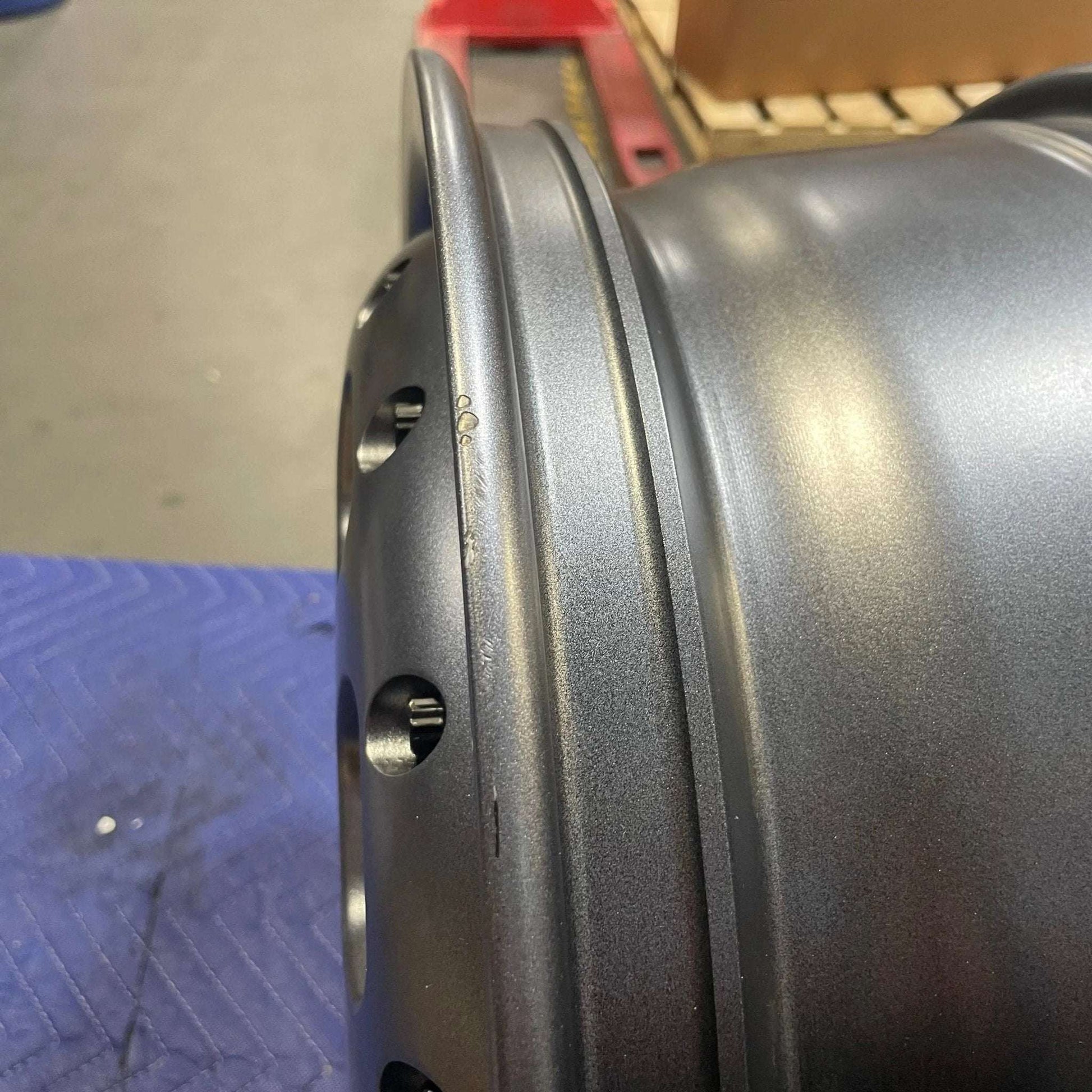 Open box Talon Transit AWD wheel in graphite grey with minor scuffs and scratches, 17x7 inches, 6x180mm bolt pattern, lightweight aluminum design.
