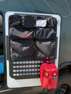 Door organizer for Winnebago Ekko with multiple compartments for gear storage.