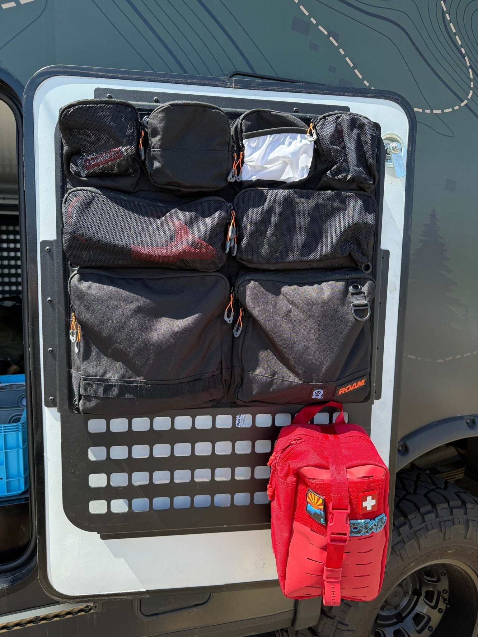 Door organizer for Winnebago Ekko with multiple compartments for gear storage.