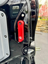 Red aluminum Grenadier rear door handle mounted on black vehicle door panel