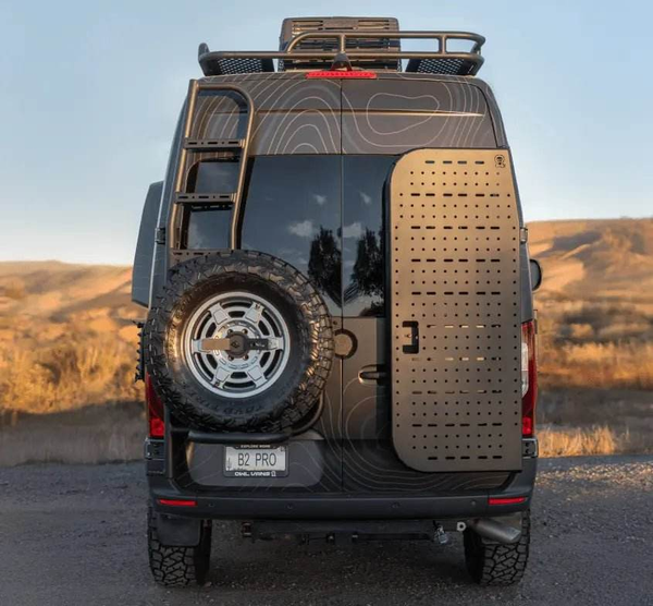 Sprinter van equipped with Owl B2 Pro rear door bike rack and box carrier with spare tire and rooftop storage rack.