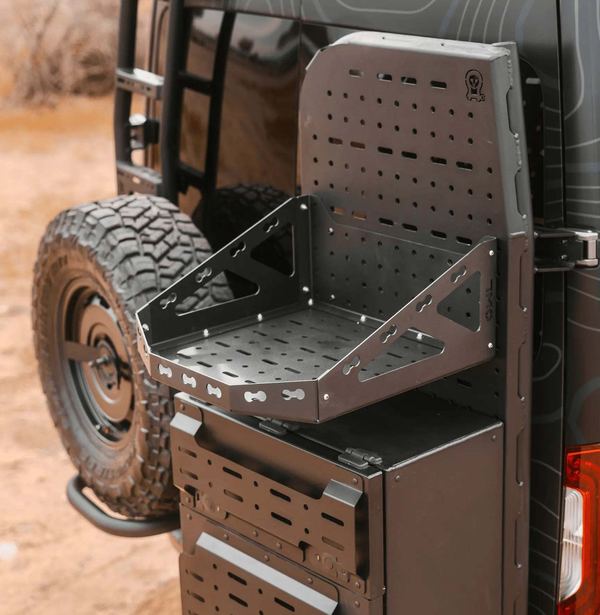 Sprinter bike rack and box carrier mounted on rear door of van with modular storage platform and rugged design