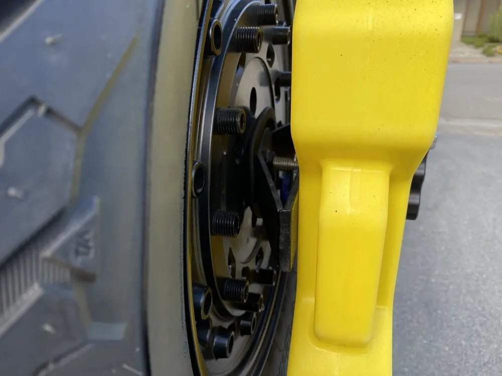 Expedition Handle 2.0 mounted on a tire carrier, showcasing CNC machined aluminum construction with black anodized finish for durability and grip.