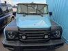 Blue INEOS Grenadier vehicle with black Grenadier Fender Armor Plates installed on fenders for durable off-road protection