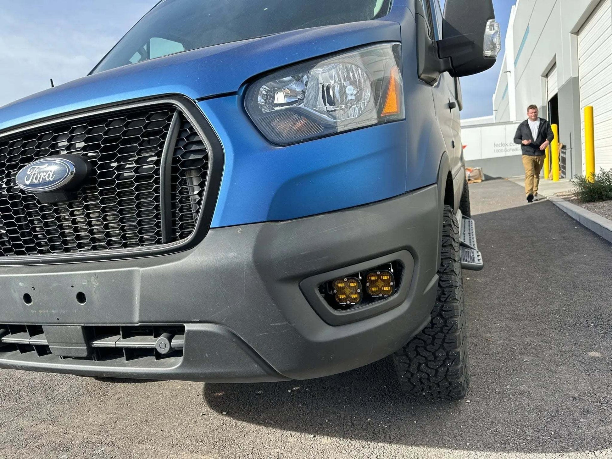 Blue Ford Transit with Owl Fog Light Bracket installed on the front bumper.