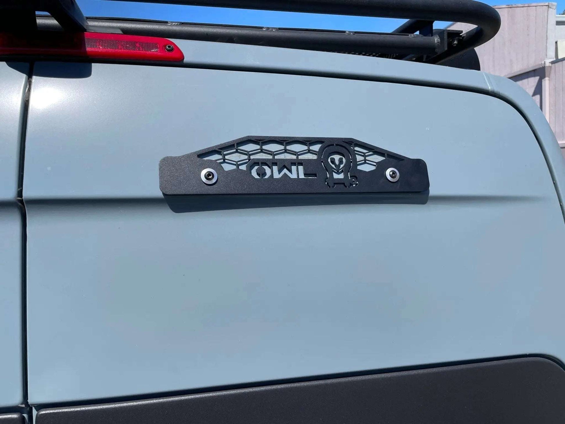 Ladder removal trim plate installed on Winnebago Revel rear door.