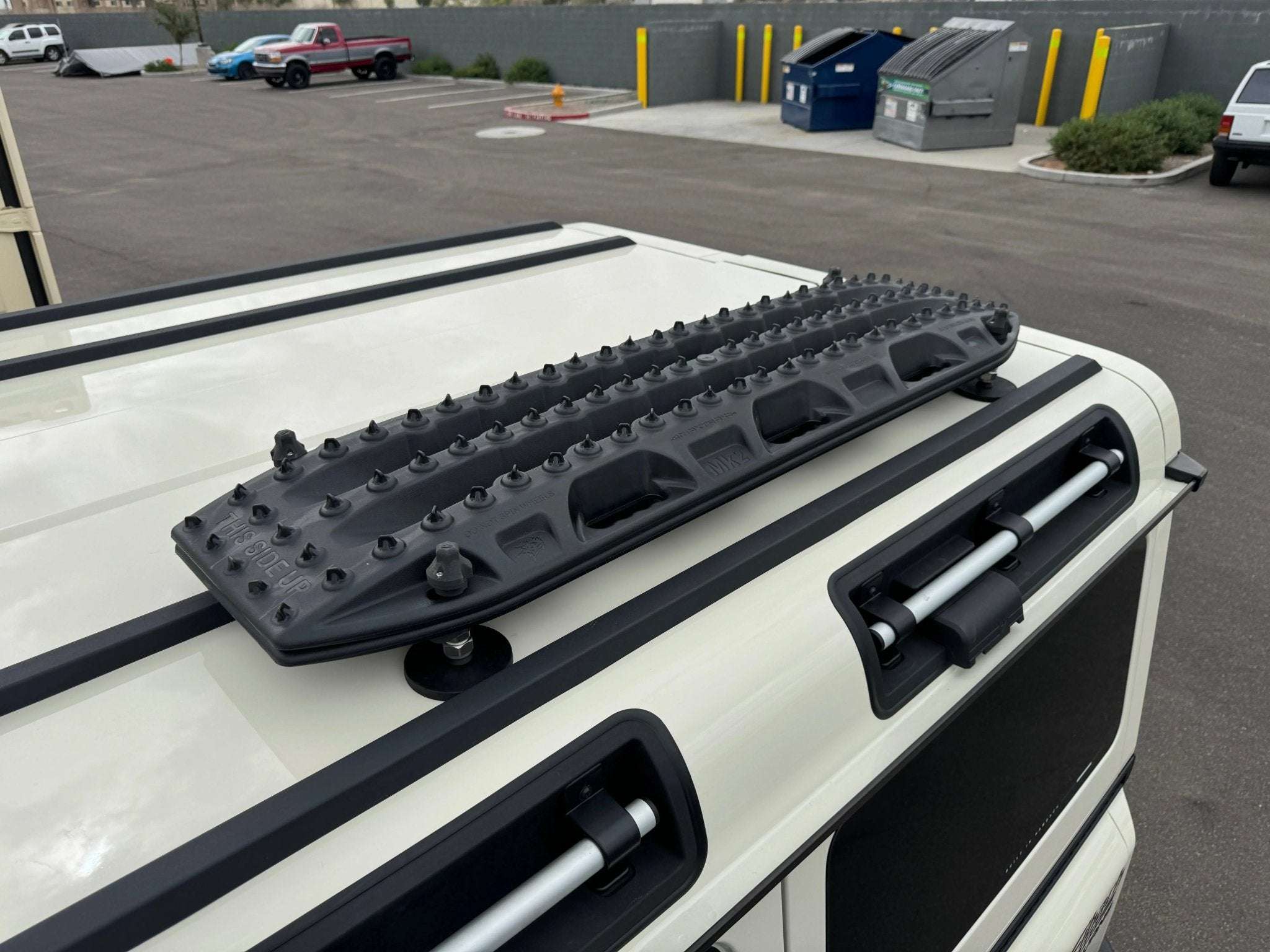 Magnetic Maxtrax Mounts for INEOS Grenadier on vehicle roof, showcasing durable and sleek design for adventurous overland setups.